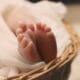 Baby on the Way - image of baby's feet in a basket