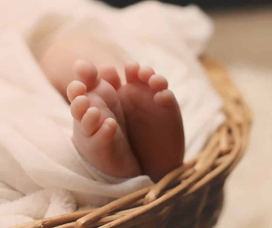 Baby on the Way - image of baby's feet in a basket