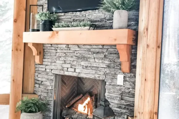 Screened-in porch with a fireplace and a grilling area